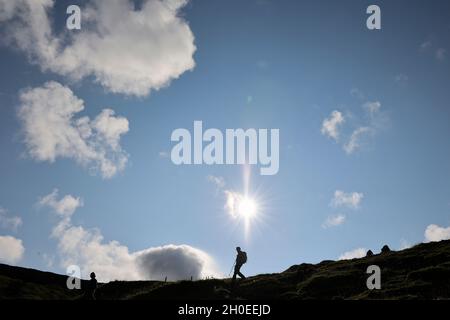 Silhouette of hikers on a mountain ridge,Tjornuvik, Streymoy Island, Faroe Islands,Scandinavia, Europe Stock Photo