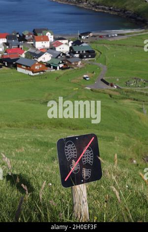 Sign Do not step on grass on a hill near Tjornuvik, Streymoy Island, Faroe Islands, Scandinavia, Europe Stock Photo