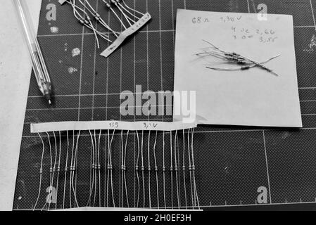 Electronic components and resistors on a workspace in black and white Stock Photo