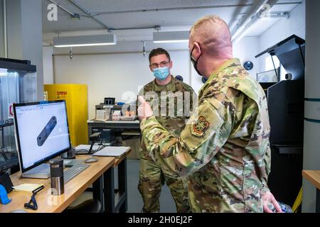 Chief Master Sgt. Chad Bickley, 18th Air Force command chief, speaks with an Airman assigned to the Bedrock innovation lab on Dover Air Force Base, Delaware, Feb. 12, 2021. Established in 2019, Bedrock’s goal is empowering Airmen to develop ideas and leverage new technologies to support the warfighter at home station or downrange. Bedrock’s new facility boasts over 5,000 square feet, housing large, collaborative workspaces, an event stage, a virtual reality classroom, a podcast studio and a prototyping lab with 3D printers. Stock Photo