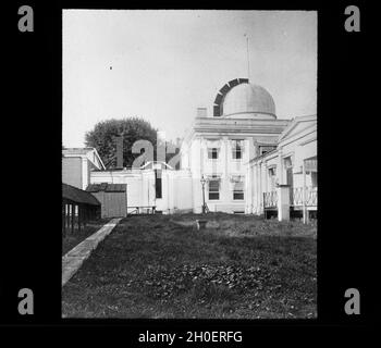 Lantern Slide 48: The west wing of the old observatory from the south. At the left is the old photoheliograph, originally purchased for the Transit of Venus expedition in 1874. Photo about 1888. Stock Photo