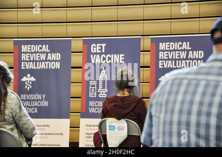 Las Vegas residents wait the required 15 minutes after receiving the COVID-19 vaccine at the Desert Pines High School point of distribution site, Friday, Feb. 19, 2021 in Las Vegas, Nevada. Stock Photo