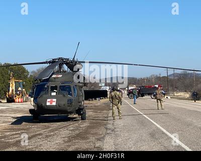 Soldiers of Charlie Company, 2-149th General Aviation Support Battalion, Texas Army National Guard deliver food and water in response to Winter Storm Uri Feb 20. 2021, at Camp Wood, Texas. Stock Photo