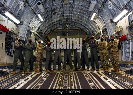 Eleven black air crew members from the 4th and 8th Airlift Squadrons, 62nd Operations Support Squadron, and the 62nd Aircraft Maintenance Squadron on Joint Base Lewis-McChord, Wash., pose at the back of a C-17 Globemaster III after completing a successful training flight and attending a heritage event for Black History Month, honoring the history and supporting the future of black Airmen. Stock Photo