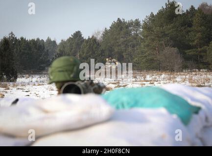 A Lithuanian soldier assigned to 21st Dragoon Battalion scans his area