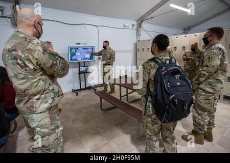 U.S. Army Cpt. Joseph Bayles, the officer in charge of the Six Flags America mass vaccination site, briefs senior leaders of the Maryland and Virginia National Guard on COVID-19 operations on Feb. 23, 2021, at the Six Flags America mass vaccination site in Bowie, Maryland. The MDNG has been activated to support Maryland's COVID-19 response by providing direct support to county health departments in assisting with the acceleration of vaccination and COVID-19 testing efforts. Stock Photo