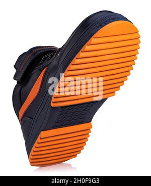 boot or sneaker with orange sole isolated on white background. Stock Photo