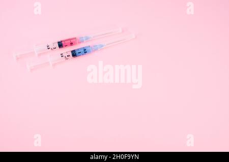 sterilized injection syringe on a pink background Stock Photo