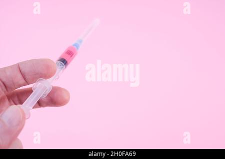 sterilized injection syringe on a pink background Stock Photo