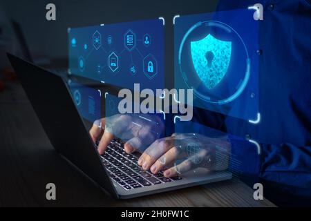 Cyber security expert working on network and data protection on laptop computer against digital crime. Privacy technology on internet. Stock Photo
