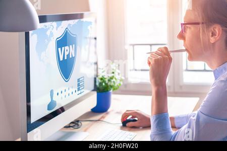 VPN secure connection for freelancer Person using Virtual Private Network technology on computer to create encrypted tunnel to remote server on intern Stock Photo