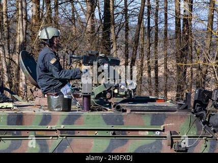 U.S. Army Soldiers assigned to the 1st Battalion, 4th Infantry Regiment, conduct the OPFOR (opposing forces) mission while riding in the M113 armored personnel carrier, at Hohenfels Training Area, Germany, Feb. 28, 2021, during Combined Resolve XV. The exercise is a Headquarters Department of the Army directed Multinational exercise designed to build 1st Armored Brigade Combat Team, 1st Cavalry Division’s readiness and enhance interoperability with allied forces to fight and win against any adversary. Stock Photo