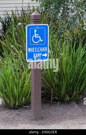 Wheelchair Access Ramp Sign with foliage background Stock Photo