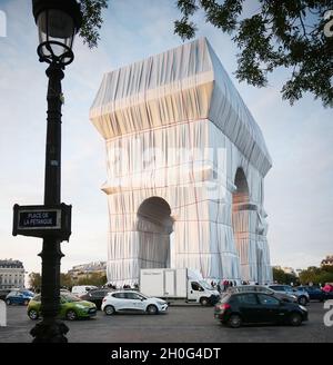 Paris -20210930 - The wrapping of the Arc de Triomphe as part of an art installation by the late artist Christo is seen on September 302021 in ParisFrance. His monumental installation envelops the emblematic Parisian monument under a blue and silver fabric of 25,000 square meters. The project "L'Arc de TriompheWrapped" by the late artist Christo and Jeanne-Claude will be on view from September 18 to October 32021. The American artist of Bulgarian origin Christo died in May 2020.  -PICTURED: L'Arc de Triomphe Wrapped Milla Cochran Stock Photo