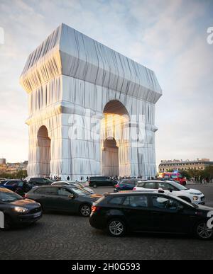 Paris -20210930 - The wrapping of the Arc de Triomphe as part of an art installation by the late artist Christo is seen on September 302021 in ParisFrance. His monumental installation envelops the emblematic Parisian monument under a blue and silver fabric of 25,000 square meters. The project "L'Arc de TriompheWrapped" by the late artist Christo and Jeanne-Claude will be on view from September 18 to October 32021. The American artist of Bulgarian origin Christo died in May 2020.  -PICTURED: L'Arc de Triomphe Wrapped Milla Cochran Stock Photo