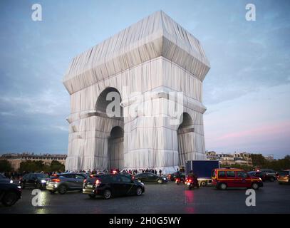 Paris -20210930 - The wrapping of the Arc de Triomphe as part of an art installation by the late artist Christo is seen on September 302021 in ParisFrance. His monumental installation envelops the emblematic Parisian monument under a blue and silver fabric of 25,000 square meters. The project "L'Arc de TriompheWrapped" by the late artist Christo and Jeanne-Claude will be on view from September 18 to October 32021. The American artist of Bulgarian origin Christo died in May 2020.  -PICTURED: L'Arc de Triomphe Wrapped Milla Cochran Stock Photo