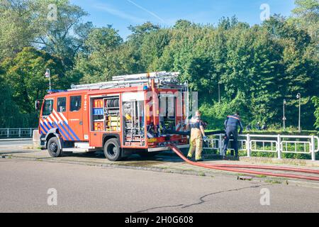Firefighters do an exercise in the city of The Hague, The Netherlands on a sunny day. Stock Photo