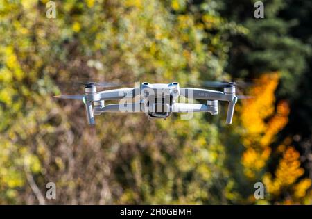 ISTANBUL, TURKEY - OCTOBER 11, 2021: DJI Air 2S Drone flying with green background. Stock Photo