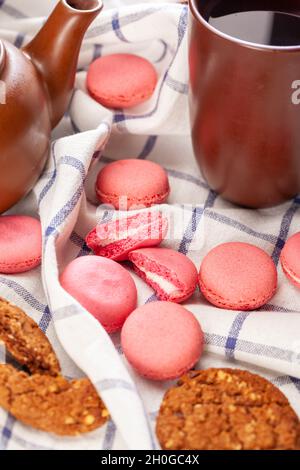 Pink tiny macaron cookies on a tablecloth close up Stock Photo