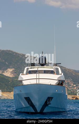 large power yacht or motor yacht off of the coast of greece, luxury motorboat off of greek island, millionaires boat, big boys toys. Stock Photo