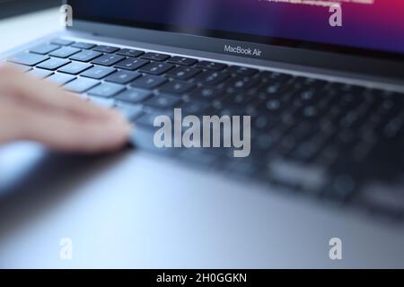 Minsk, Belarus, October 11, 2021: Woman uses an Apple Macbook Air Stock Photo