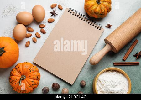 Ingredients for preparing pumpkin pie and notebook on table Stock Photo