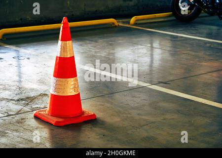 Reflective traffic safety cone in a closed parking lot Stock Photo