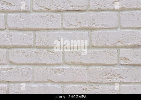 White fresh-painted surface of brickwork facade of old renovated building. White brick wall background.  Stock Photo