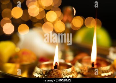 Illuminated Metal Brass Lamp Called Diya Deep Or Dia Glowing With Bokeh. Theme For Diwali, Navratri, Dussehra Puja, New Year, Deepawali, Karva Chauth, Stock Photo