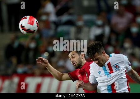 Faro, Portugal. 12th Oct, 2021. Portugal's forward Bernardo Silva (L) vies with Luxembourg's defender Michael during the FIFA World Cup Qatar 2022 qualification group A football match between Portugal and Luxembourg, at the Algarve stadium in Faro, Portugal, on October 12, 2021. (Credit Image: © Pedro Fiuza/ZUMA Press Wire) Stock Photo