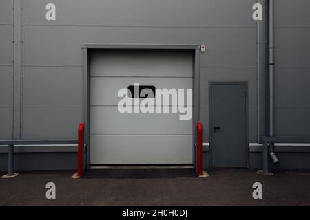 Closed door of transport terminal for truck deliveries and loading. Stock Photo
