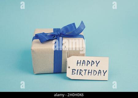 A birthday tag with a red ribbon and bow. The text 'Happy Birthday' on the  top Stock Photo - Alamy