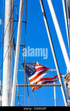 American flag in tatters on a commercial fishing vessel docked in Steveston British Columbia Canada Stock Photo