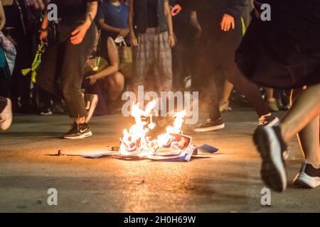 Barcelona, Spain. 12th Oct, 2021. Pictures of President of the Madrid community, Isabel Diaz Ayuso are seen on fire.Various anticolonialist groups have called a demonstration that left the Ramblas of Barcelona to the statue of Christopher Columbus, with the slogans 'they will not conquer us' and 'nothing to celebrate'. The groups protested against the celebration of October 12, Hispanic Day. Various cultural presentations and performances of native peoples from Latin American and African countries have been carried out. Credit: SOPA Images Limited/Alamy Live News Stock Photo