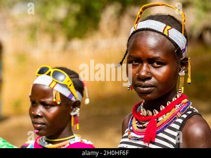 Traditional dressed young girls from the Laarim tribe in front of their ...