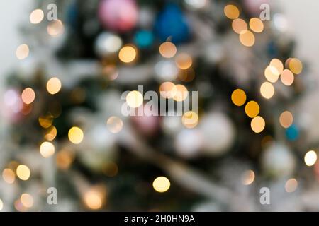 Blurred background with blinking lights of christmas tree. Stock Photo