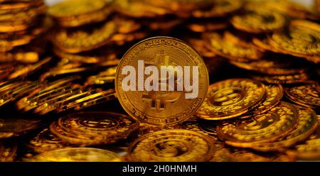 Bitcoin cryptocurrency on pile gold coins a lot of Stock Photo