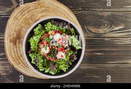 Eggplant salad with feta cheese, pomegranate and currants in a coffee marinade. French gourmet cuisine Stock Photo