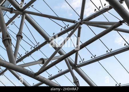 Abstract contemporary architectural photo. Internal structure of roof with metal frame and glass