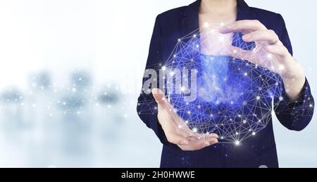 Global database and artificial intelligence. Two hand holding virtual holographic Artificial intelligence icon with light blurred background. Artifici Stock Photo