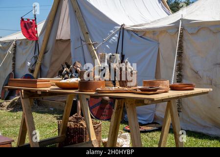 Eungella, Queensland, Australia - October 2021: A viking village re-enactment fair with medieval objects on display on a wooden table with tents in th Stock Photo