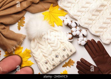 Warm autumn-winter clothes accessories on a white background. Hat gloves sweater scarf shoes. Flat lay top view Stock Photo
