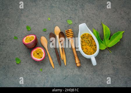 Fresh passion fruits set up on dark stone background. Passion fruits and juice with pepper mint leaves. Healthy food backgroud concept. Stock Photo