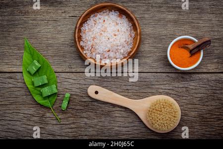Alternative skin care and homemade scrubs with natural ingredients himalayan pink salt ,turmeric  and aloe vera set up on rustic wooden background. Stock Photo