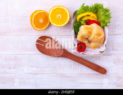Clean food breakfast croissant and salad on wooden table. Stock Photo