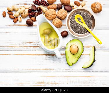 Selection food sources of omega 3 and unsaturated fats. Super foods high vitamin e and dietary fiber for healthy food on wooden background. Stock Photo