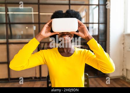 beautiful young woman with the afro haircut working in the office Stock Photo