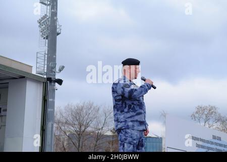 The OMON (riot police) officer performs patriotic songs for the guests of the festival. The final of the cultural and sports festival of the Central District of the Russian National Guard Troops took place in the Luzhniki sports complex. Stock Photo