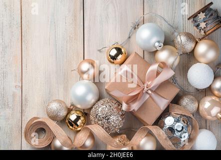 Gift box and Christmas decorations on beige background. Stock Photo