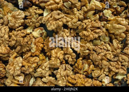 Background from a pile of peeled walnut halves. Top view. Close-up Stock Photo